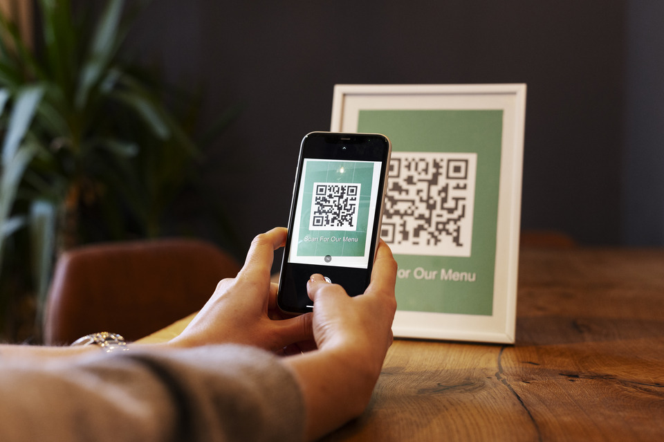 Person scanning creative personalized QR code
